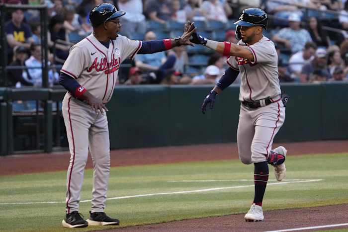 Jun 2, 2023; Phoenix, Arizona, USA; Atlanta Braves left fielder Eddie Rosario (8) slaps hands with Atlanta Braves third base coach Ron Washington (37) after hitting a solo home run against the Arizona Diamondbacks during the second inning at Chase Field.